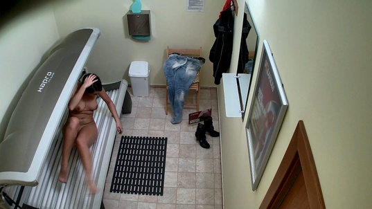 3. Download full pics of Brunette Babe Caught Stripping in Solarium from czechsolarium.com